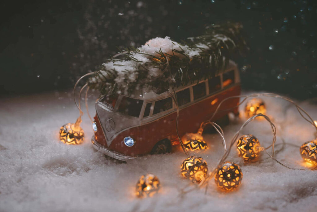 Vintage Van with Christmas Tree Wallpaper: Festive Holiday Background