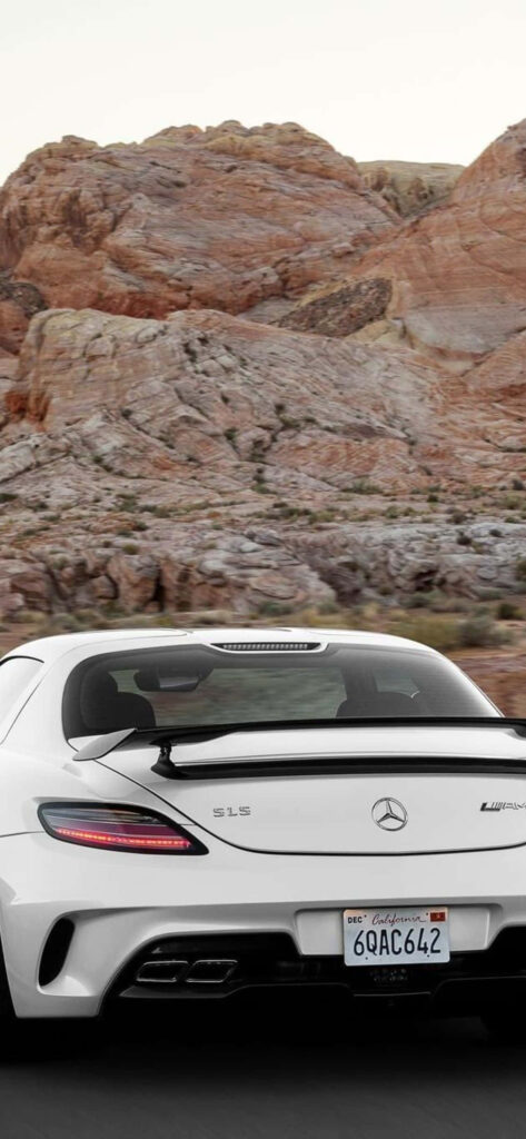 White 2014 Mercedes-Benz SLS AMG rear view on rocky landscape showcasing sleek sporty design Wallpaper
