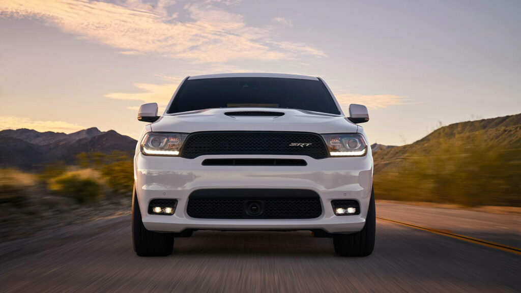White Durango SUV low angle on open road bold grille dynamic design mountain backdrop wallpaper
