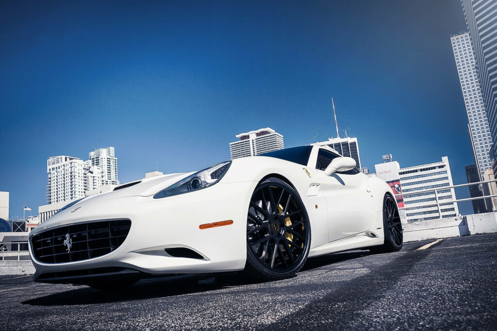 Redefining Urban Elegance: Captivating White Ferrari on Rooftop Amidst Cityscape Wallpaper