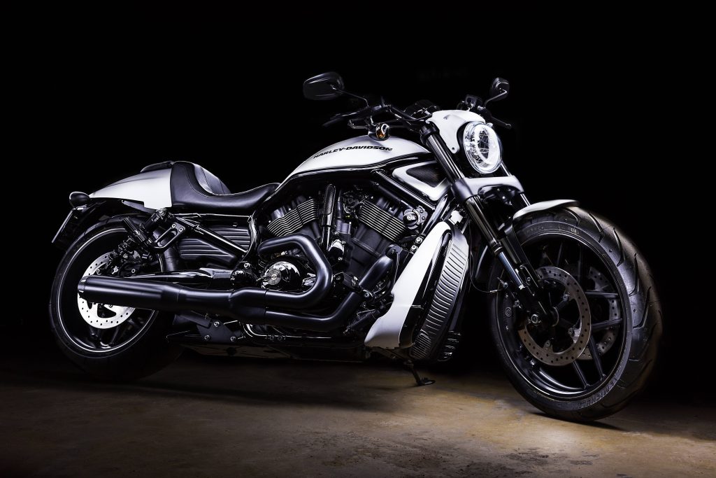 White Harley-Davidson V-Rod motorcycle with sleek muscle design on black spotlight background Wallpaper