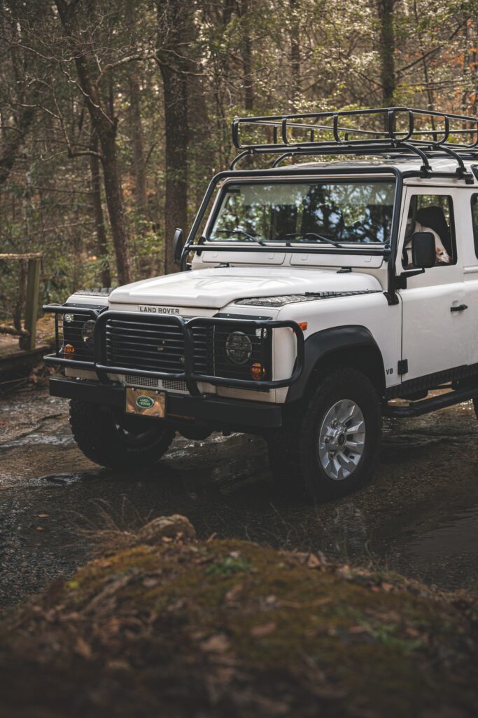 Rugged White Land Rover Defender in Serene Forest Wallpaper