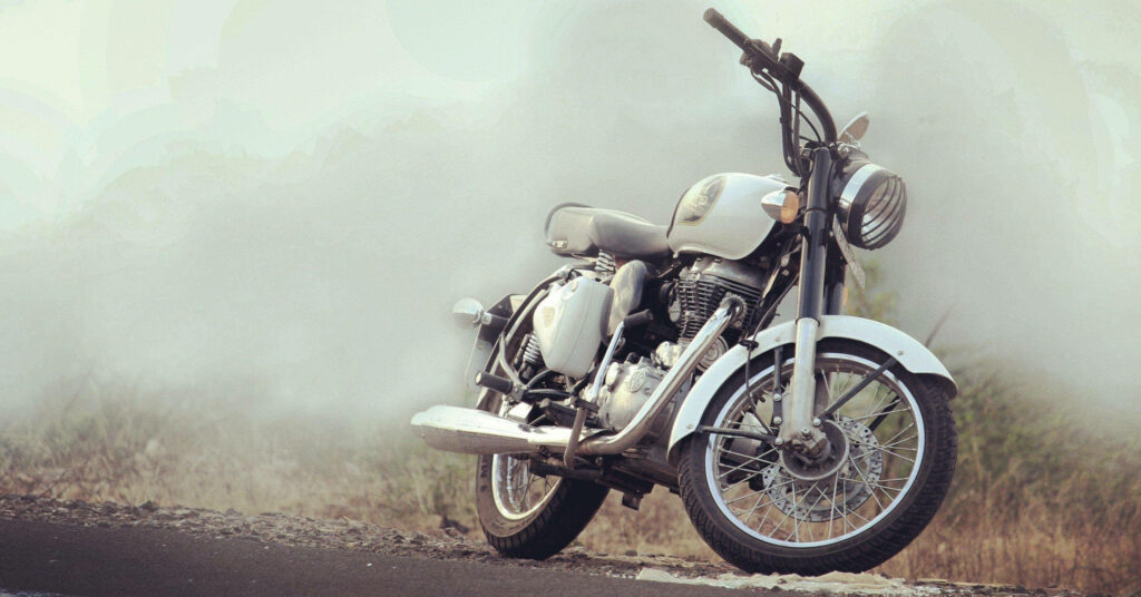 Majestic White Royal Enfield Motorcycle Immersed in HD Desert Serenity Wallpaper