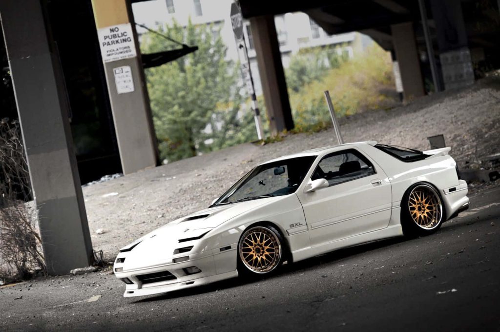 White Mazda RX-7 FC GXL with gold mesh wheels under urban bridge classic JDM sports car wallpaper