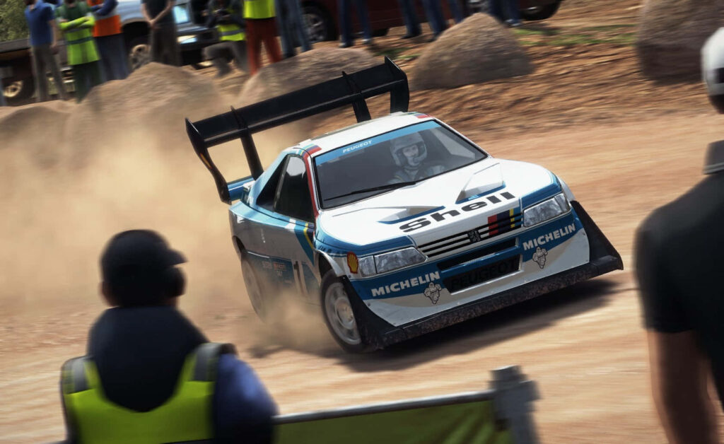 The Exhilarating White Michelin Race Car Soaring with Shell Wings in the Dirt Rally Masterpiece Wallpaper