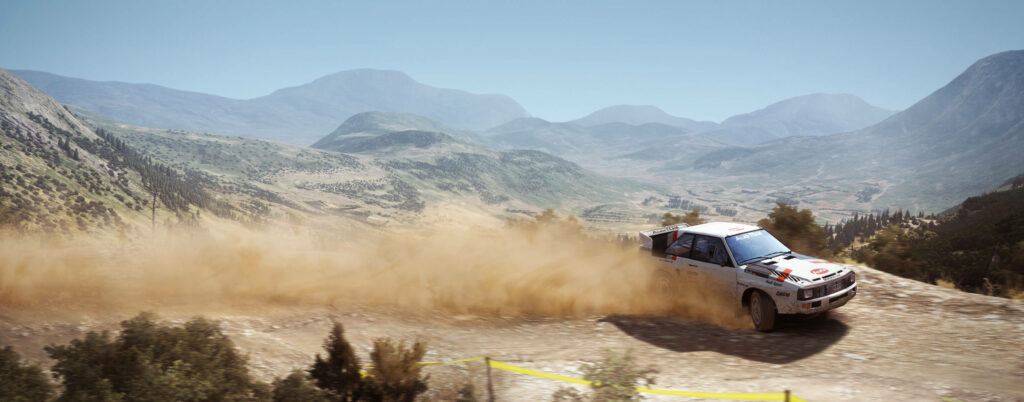 Thrilling Racing Through Majestic Mountain Peaks in 'Dirt Rally' Game Wallpaper