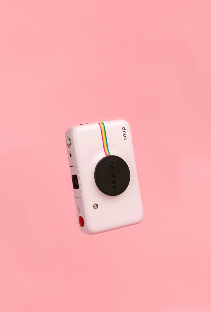 Retro Polaroid Snap Camera Wallpaper on Minimalistic Pink Background