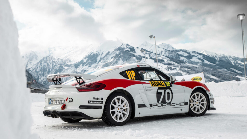 Snowbound Speed Demon: Capturing the Sleek Porsche Cayman in Dirt Rally's Mountainous Course Wallpaper