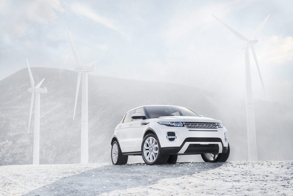 White Range Rover SUV with Wind Turbines: Eco-Friendly Adventure Wallpaper