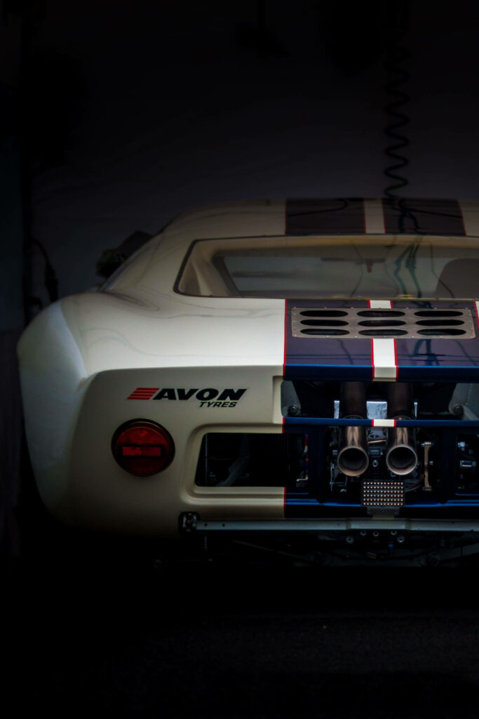 White sports car with Avon Tyres branding rear view dynamic racing design wallpaper background