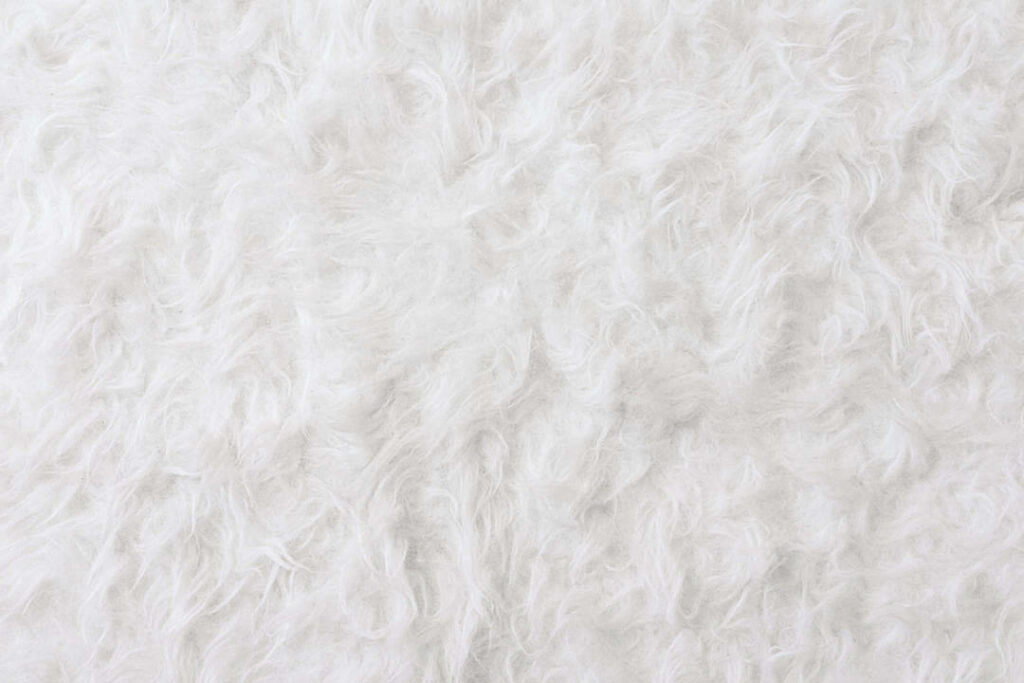 Softness Exemplified: Exploring the Subtle Beauty of a White Fur Rug's Texture Wallpaper
