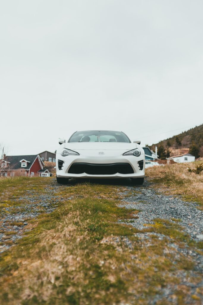 White Toyota GT86 in Picturesque Village: Scenic Wallpaper Background
