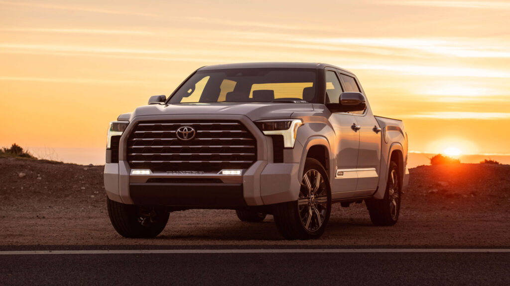 White Toyota Tundra parked at vivid sunset scenic outdoor adventure wallpaper background