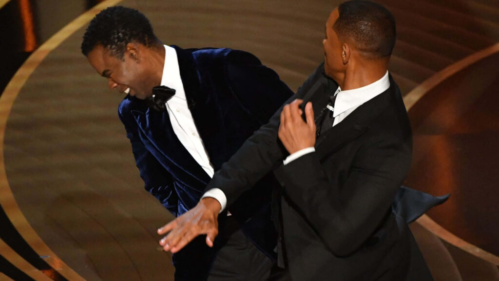 Will Smith slapping Chris Rock dramatic Oscars moment vivid colors dynamic motion wallpaper background