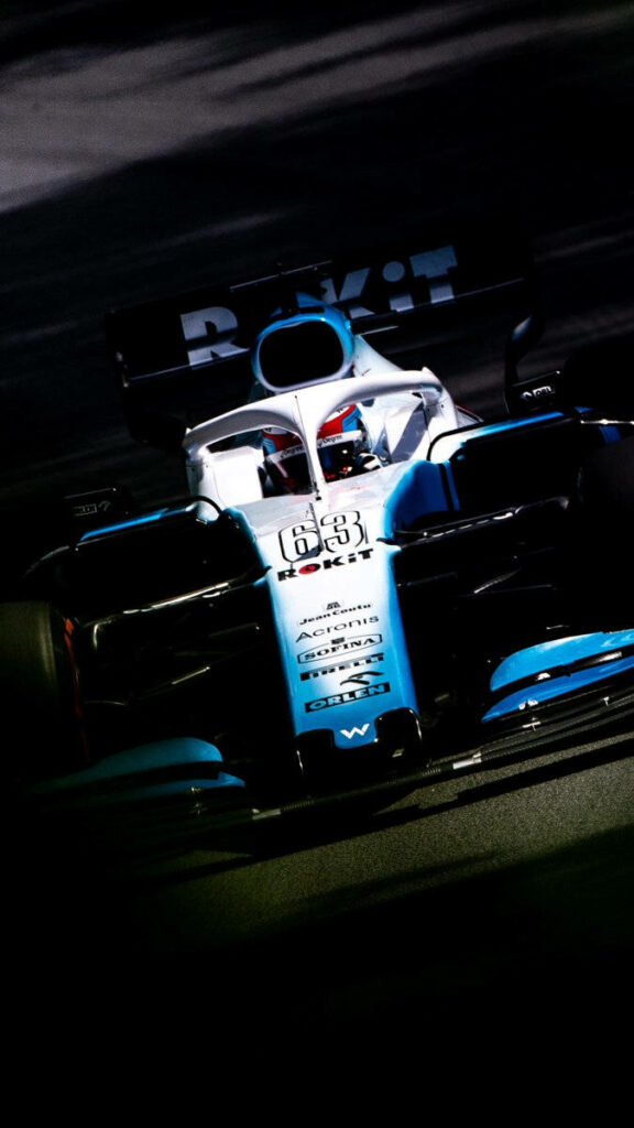 Williams Car 63 in blue and white livery illuminated on track spotlight wallpaper background