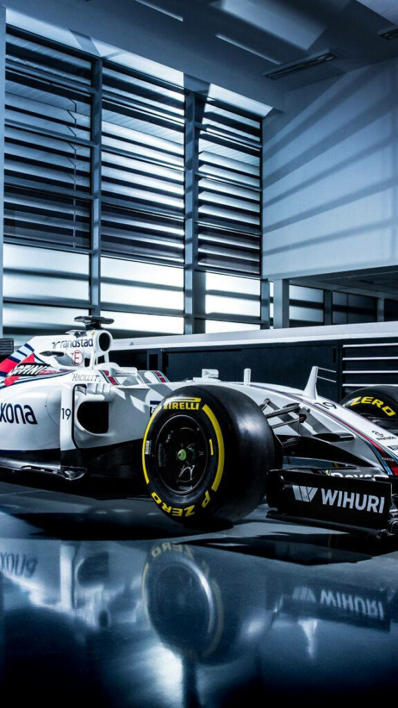 Williams Formula 1 car parked indoors on polished floor with modern architecture and lighting Wallpaper