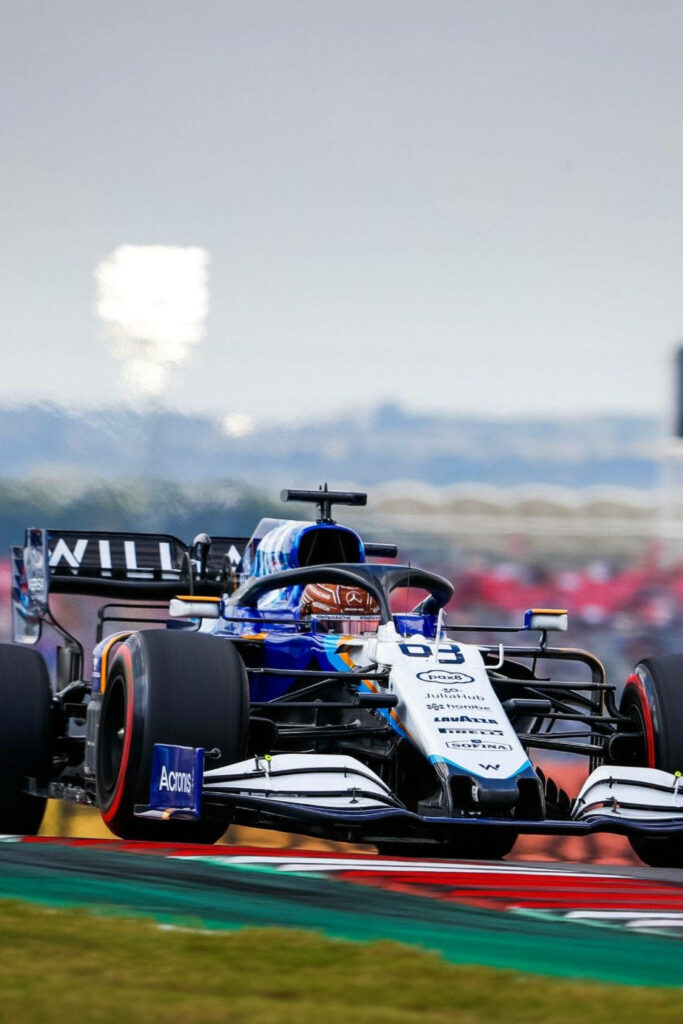 Williams Formula 1 car racing on track at sunrise dynamic motorsport wallpaper background