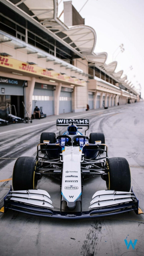 Williams Racing F1 car in modern pit lane with aerodynamic design and striking team livery Wallpaper