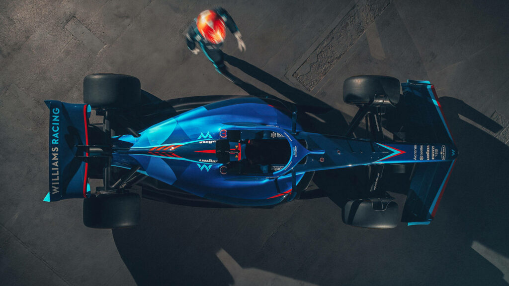 Top view of blue Williams Racing Formula 1 car showing sleek aerodynamics on sunny track Wallpaper