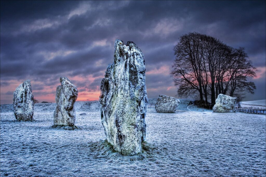 Wiltshire standing stones in frost covered field at sunrise winter sky ancient monument wallpaper