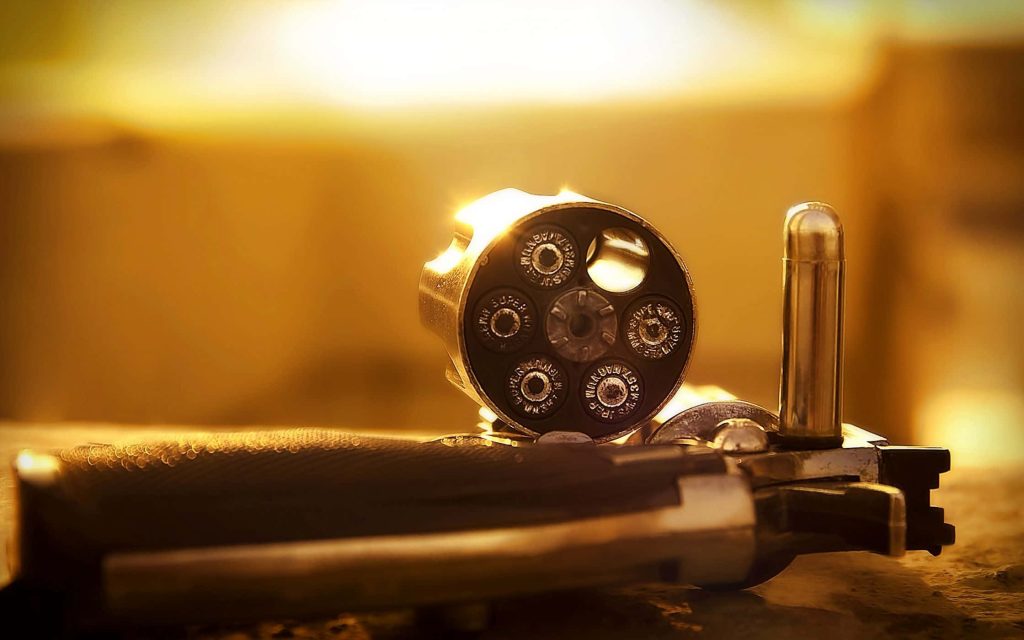 Close-up of Winchester 357 Magnum revolver cylinder in warm sunset golden light wallpaper