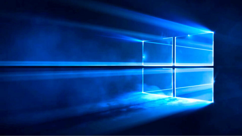 Windows 10 Hero wallpaper with glowing blue logo beams through glass in dark high-tech setting