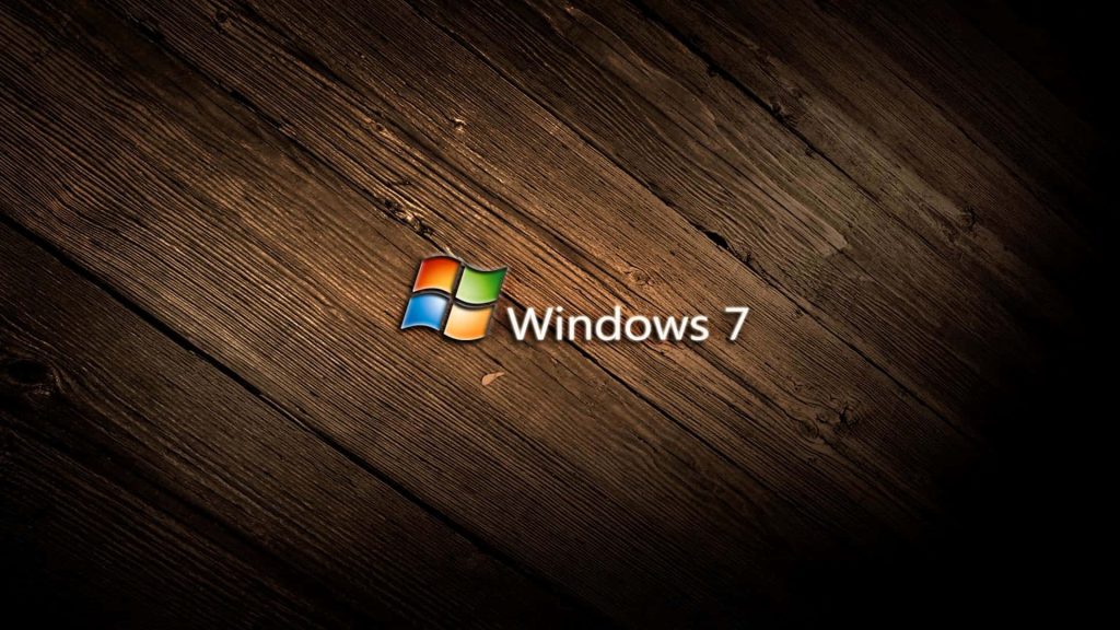 Windows 7 wallpaper with vibrant logo on dark rustic wooden plank background and vignette effect