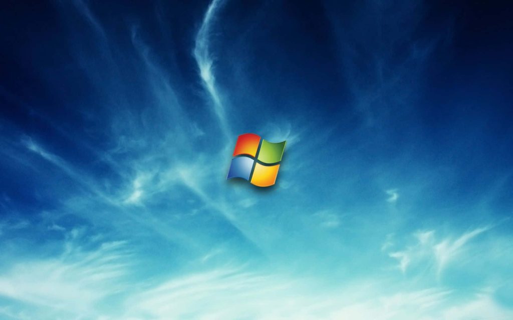 Windows 7 wallpaper bright blue sky with iconic colorful four-pane Windows logo floating centered