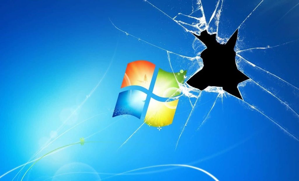 Windows 7 wallpaper with multicolored logo and shattered glass effect on bright blue background