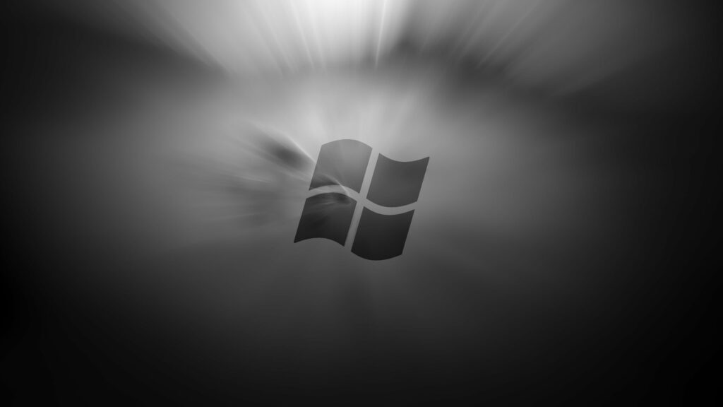 Sleek Windows 8 logo on dark minimalist background with soft radial light bursts HD wallpaper