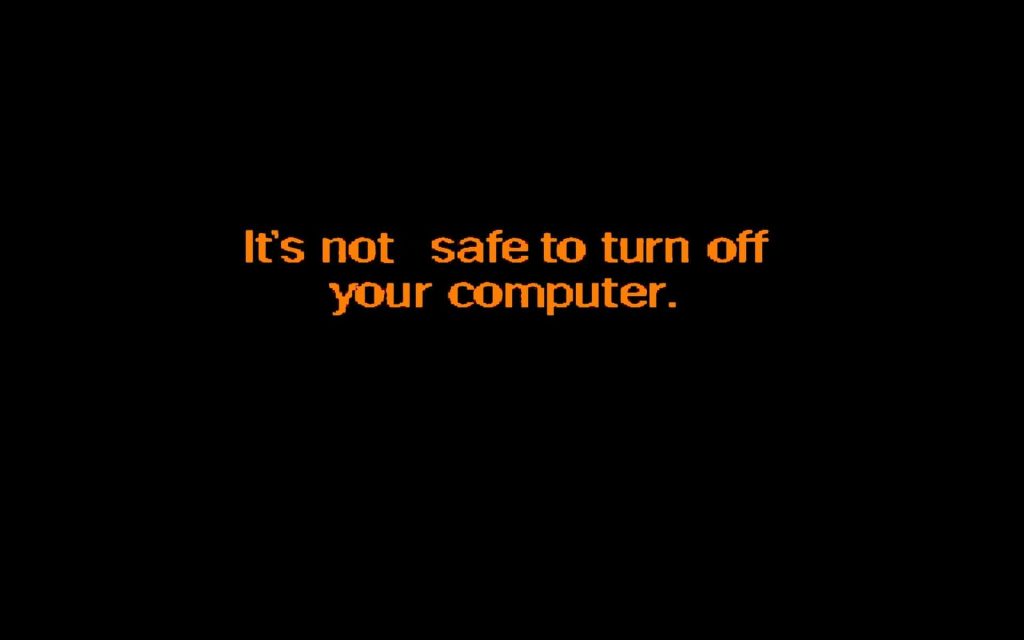 Classic Windows 95 shutdown screen with orange text on black background nostalgic wallpaper