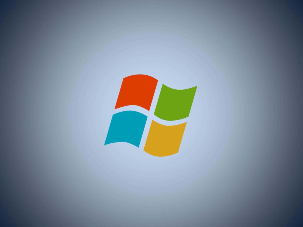 Windows 98 logo wallpaper with vibrant retro flag on blue-gray gradient background vintage tech