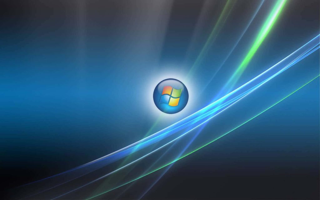 Windows Vista wallpaper with glowing logo orb and abstract blue green light waves background