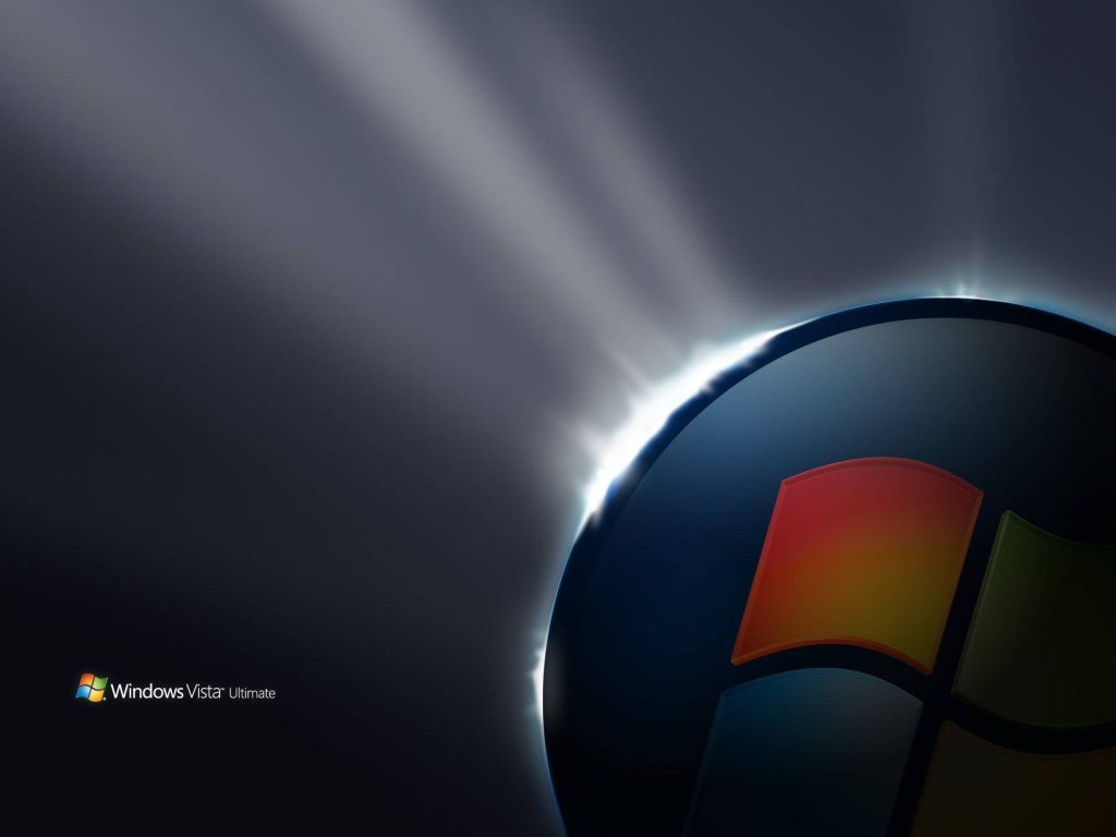 Windows Vista Ultimate logo with glowing 3D orb and eclipse halo on dark professional wallpaper background