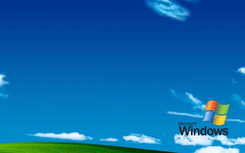 Windows XP Bliss wallpaper with green hills blue sky classic Microsoft logo desktop background