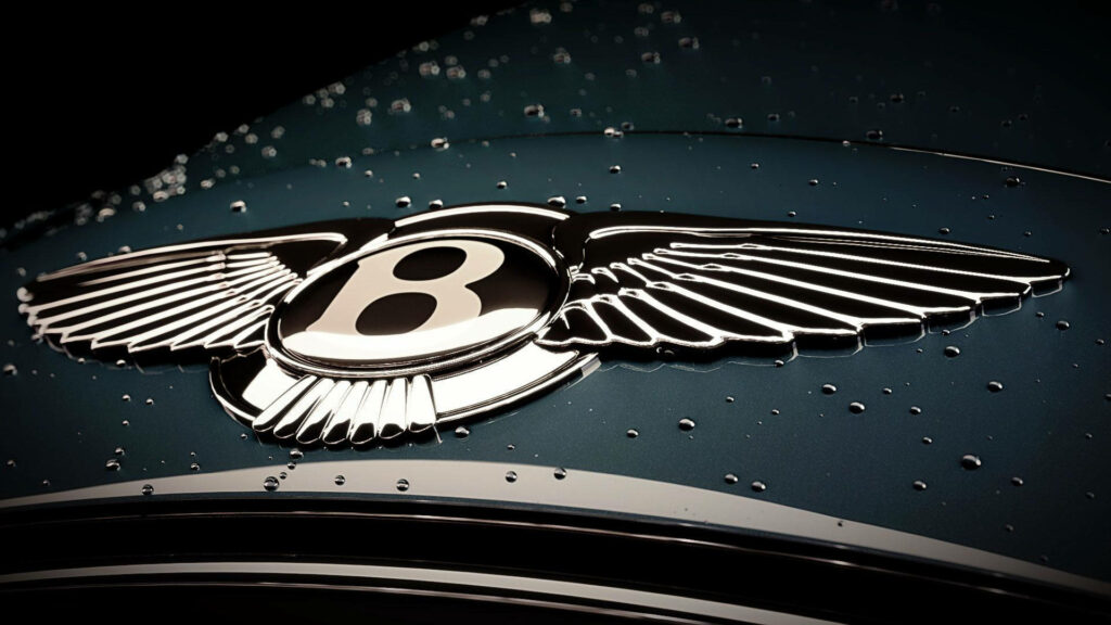 Innovative Bentley Motors Limited Emblem with Glistening Water Droplets: A Captivating Capture Wallpaper