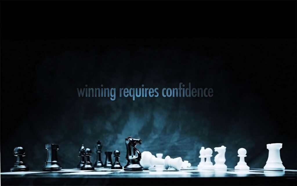 Chessboard under blue light with black and white pieces and winning requires confidence phrase Wallpaper