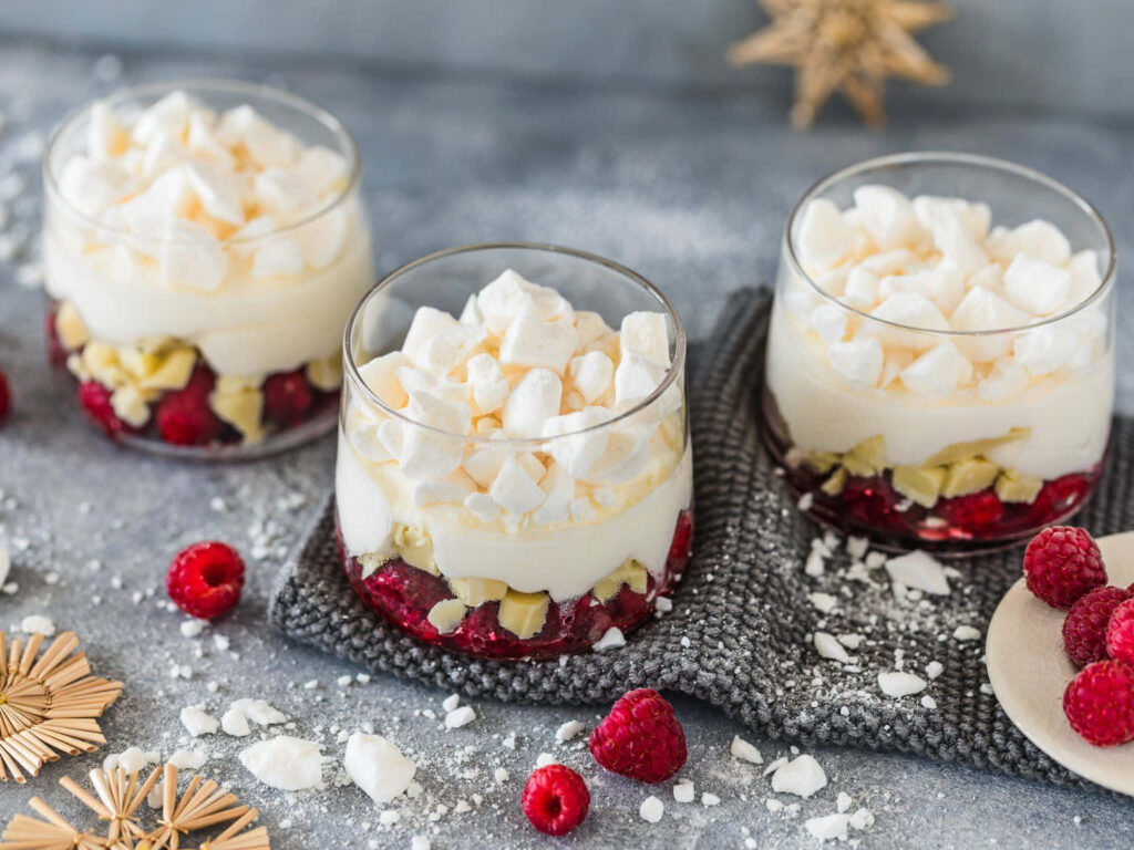Winter Wonderland of Delightful Treats: Indulge in Heavenly Apple Pie, Decadent Chocolate Cake, and Velvety Pudding, Awash in Festive Charm, Showcased on a Rustic Wooden Table Wallpaper