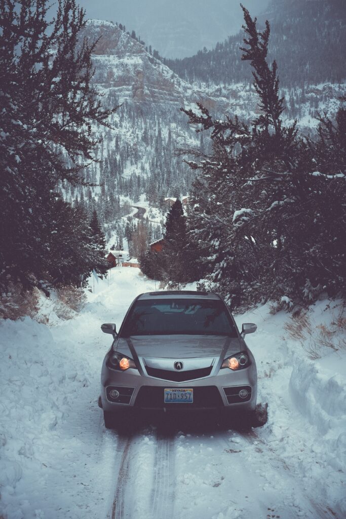 Snowy Winter Landscape Car Wallpaper with Trees and Distant Hills