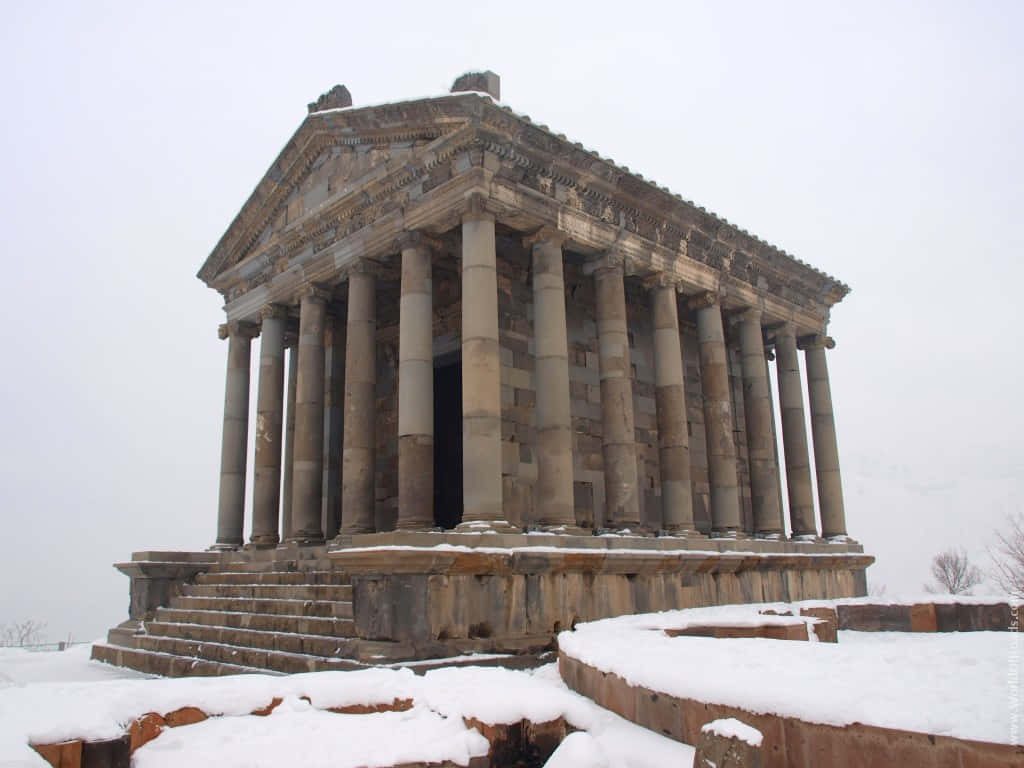 Garni Temple Armenia winter scene majestic Greco Roman columns snow covered ancient landmark Wallpaper