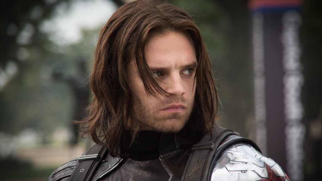 Close-up of Winter Soldier Bucky Barnes with metal arm in tactical gear natural blurred background Wallpaper