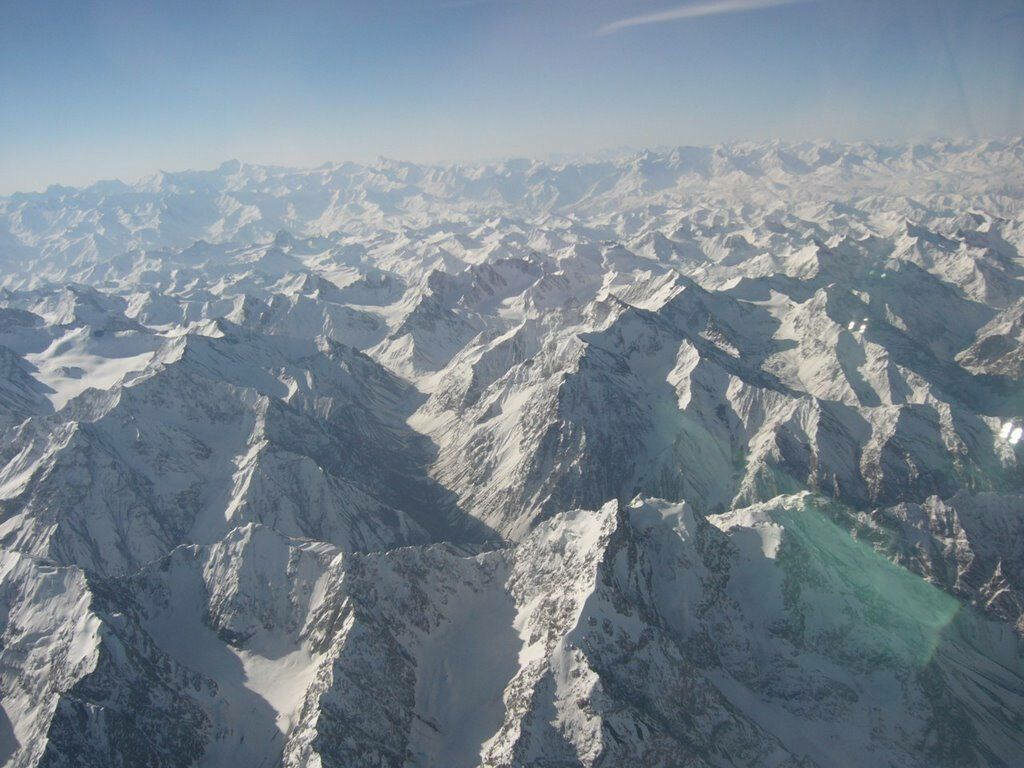 Winter Wonderland in Tajikistan: Majestic Snow-Covered Mountain Ranges Create a Breathtaking Backdrop Wallpaper
