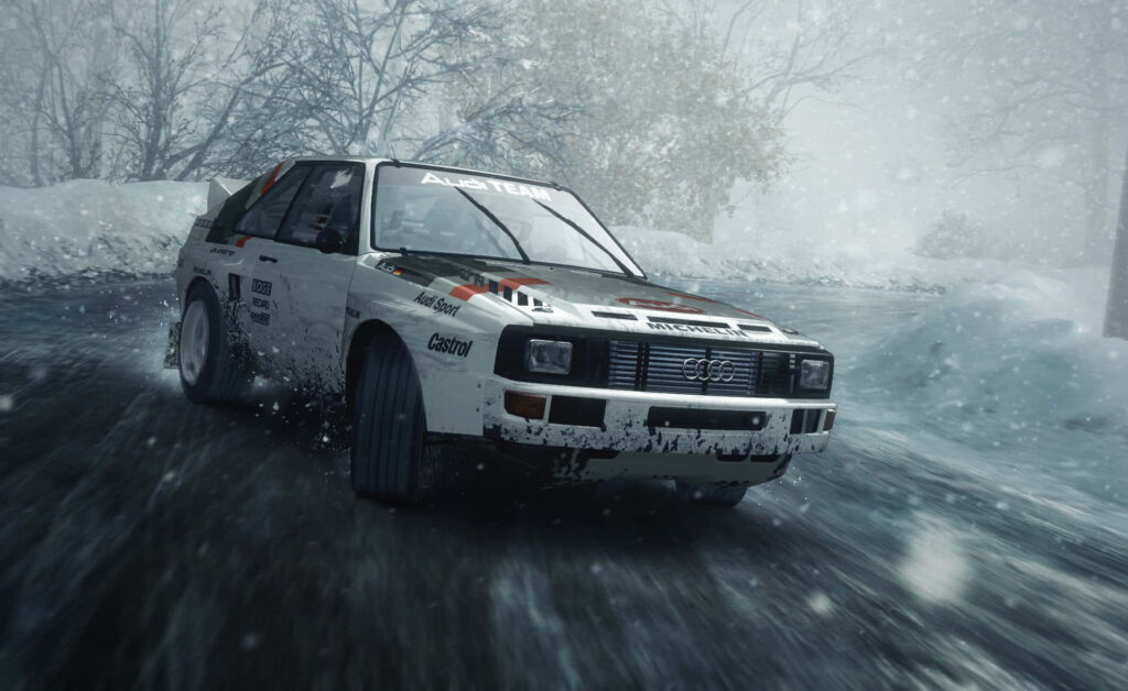 Classic Audi rally car powersliding on snowy track in intense dirt rally scene Wallpaper