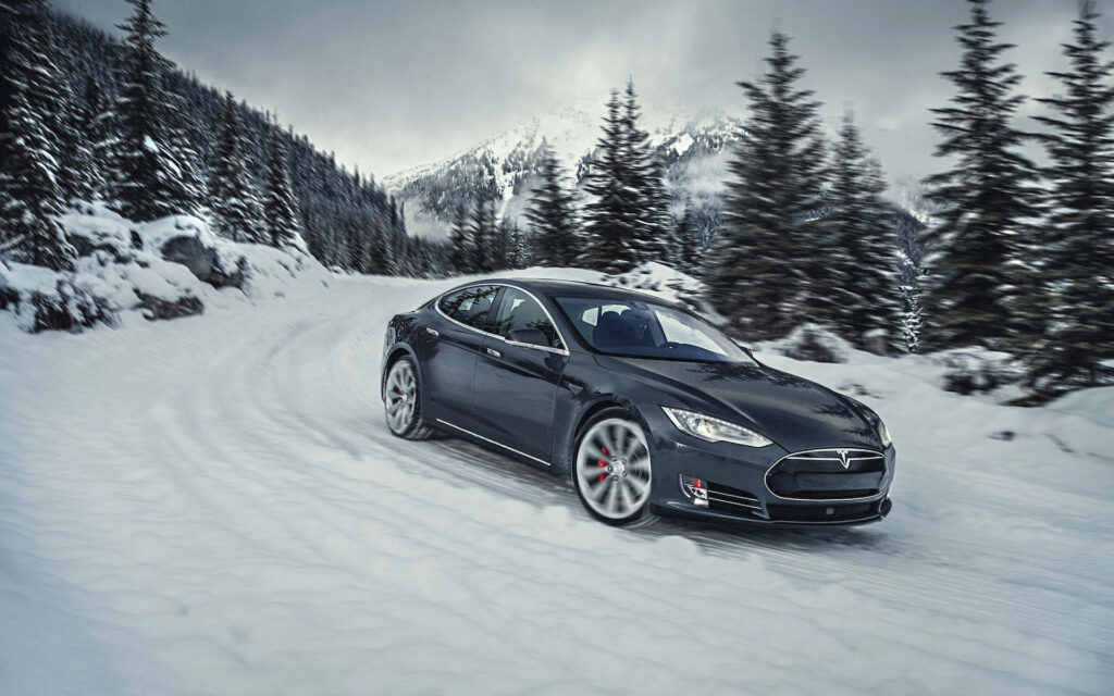 Electric Adventure: Tesla Model S Drifting Through Winter Wonderland Wallpaper