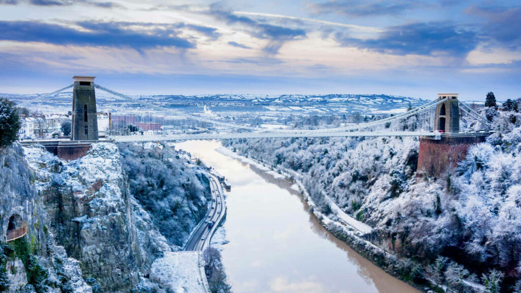 Snowy Winter Wonderland Featuring the Majestic Clifton Suspension Bridge and River Avon in Bristol, England Wallpaper