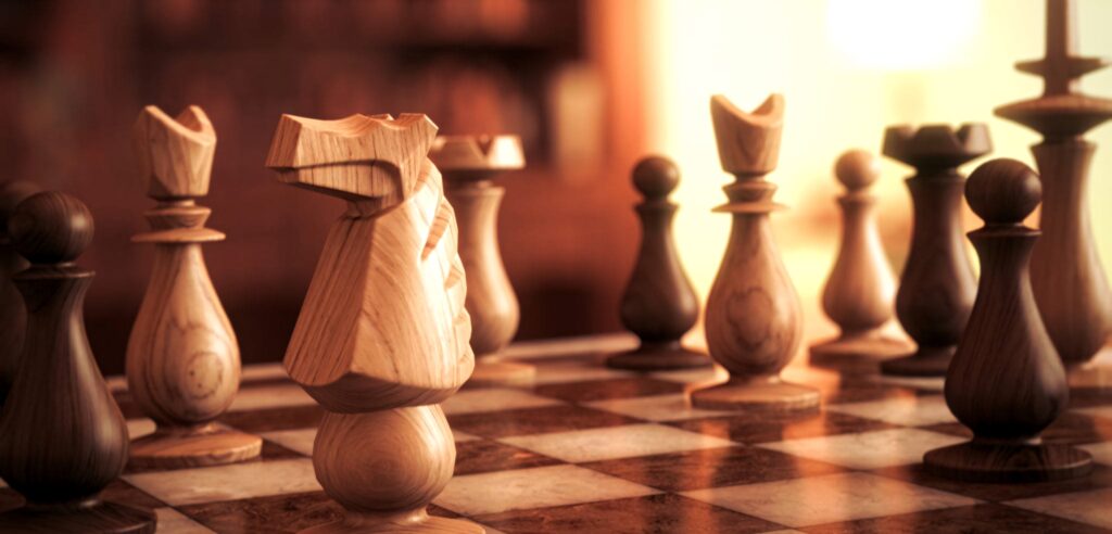 Wooden king chess piece on classic board with blurred pieces warm dramatic lighting wallpaper