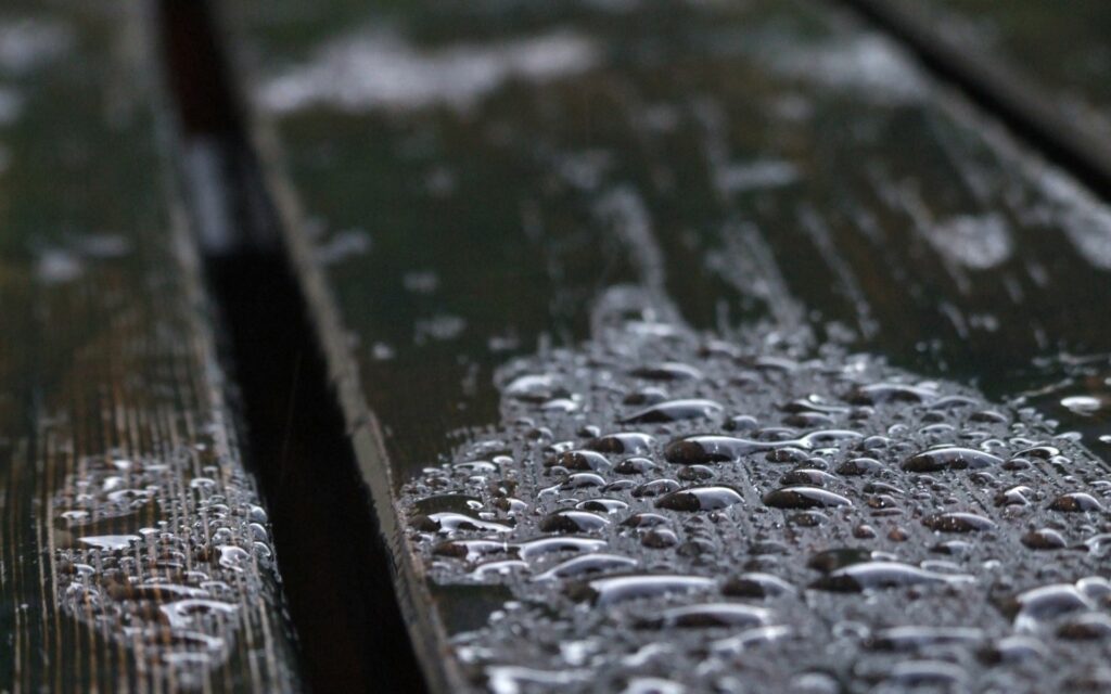 Close-Up of Wooden Surface with Water Droplets - Reflective Wallpaper