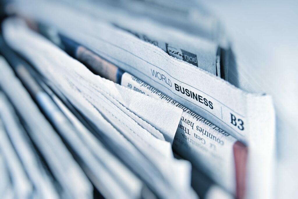 High-resolution image of WORLD BUSINESS newspaper header B3 with blurred cool-toned background Wallpaper