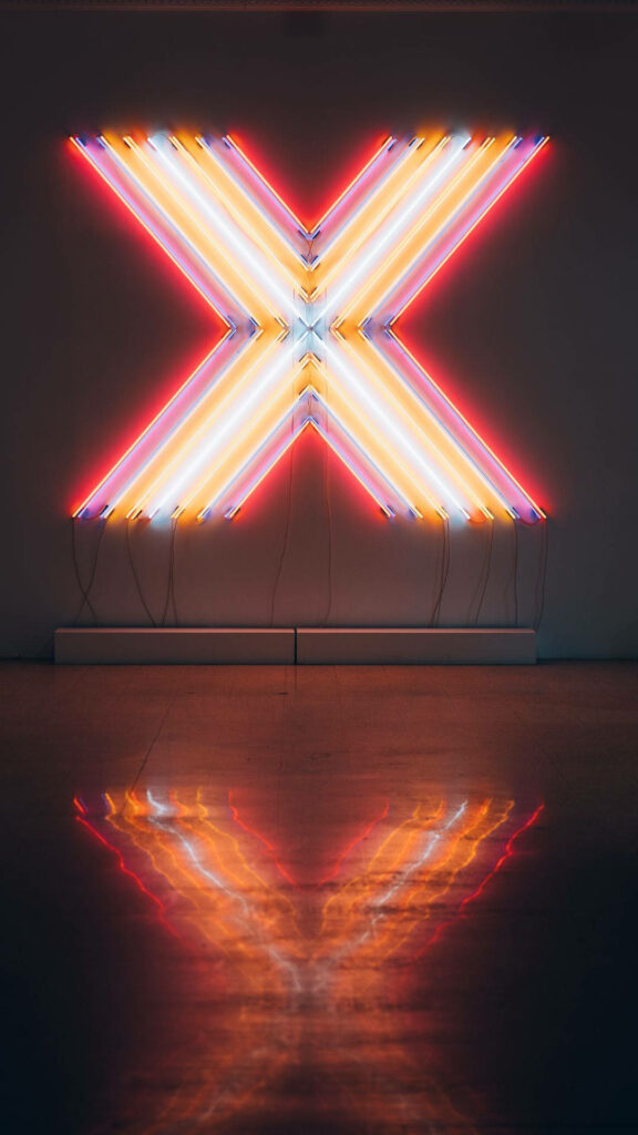 Vibrant X: Neon Reflections of Alphabet Letter Signage Create Mesmerizing Phone Background Wallpaper