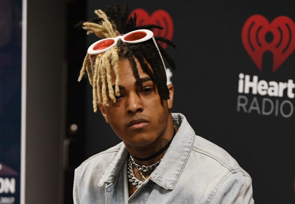 Xxxtentacion Rocks a Hip Denim Look with Fiery Red Shades on his Computer Wallpaper